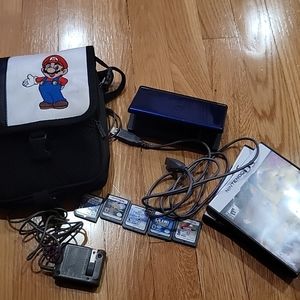 nintendo ds lite with a bag and 5 games